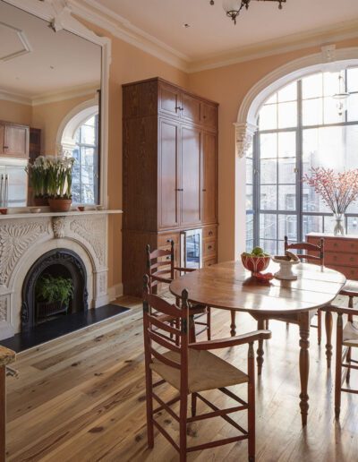 A dining room with a wooden table and chairs.