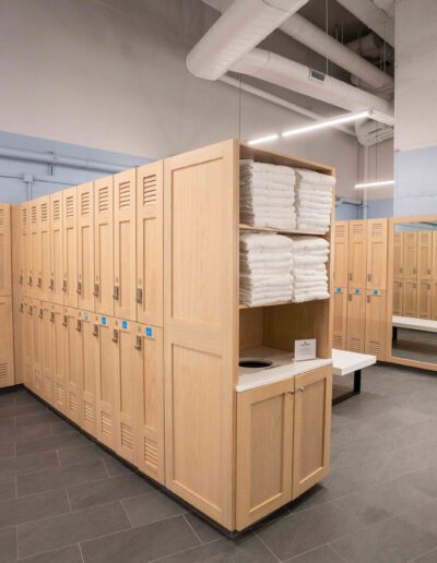 A locker room with wooden lockers and towels.