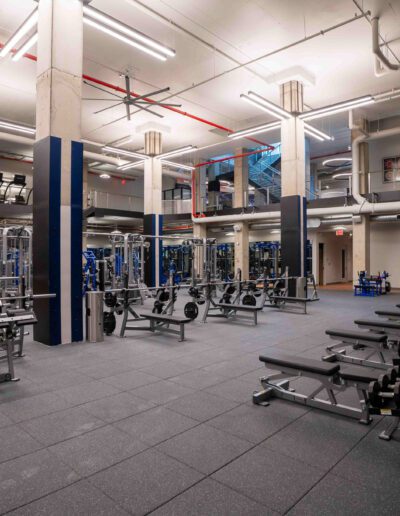 A gym with a lot of equipment in it.