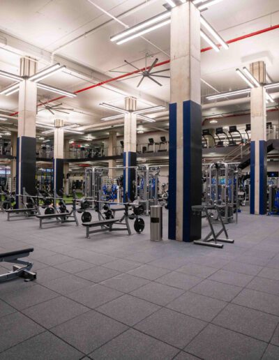 A gym with a lot of equipment in it.