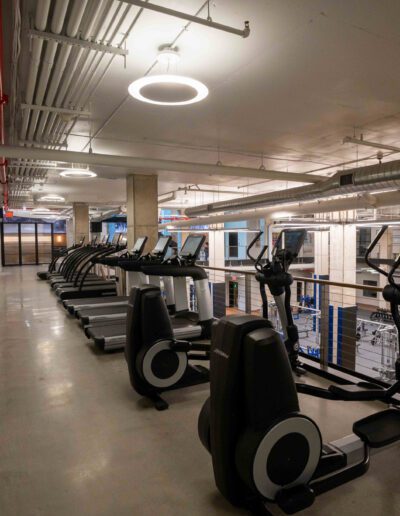 A gym with a row of tread machines.