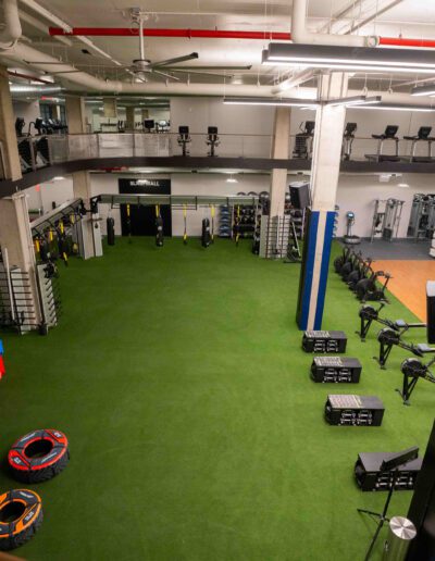 A gym with a lot of equipment in it.