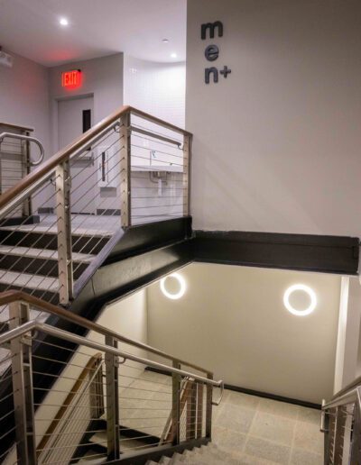 A stairway with metal railings and a sign.