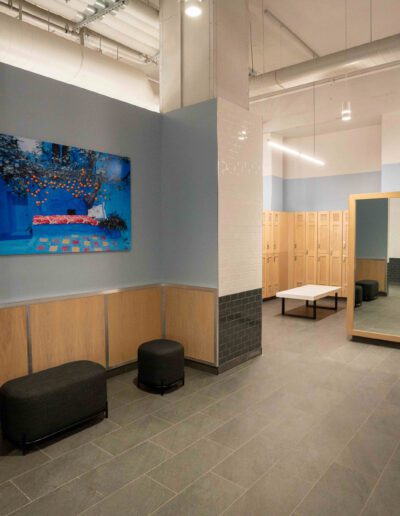 A locker room with a painting on the wall.